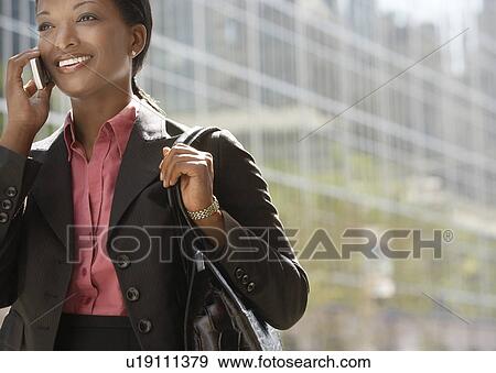 Businesswoman using mobile phone outdoors View Large Photo Image Stock Photo - Businesswoman using mobile phone outdoors. Fotosearch