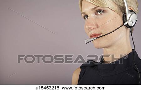 Businesswoman wearing headset close-up portrait View Large Photo Image Stock Photo - Businesswoman wearing headset close-up portrait. Fotosearch