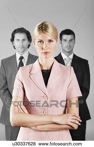 Businesswoman with Businessmen in Background View Large Photo Image Stock Photo - Businesswoman with Businessmen in Background. Fotosearch