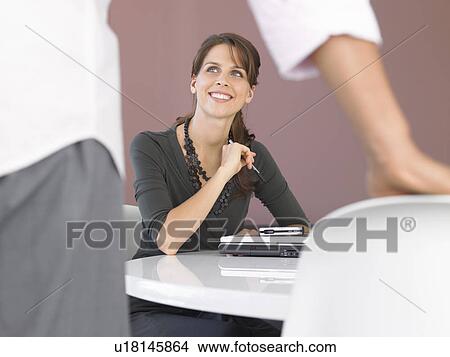 Picture - Businesswoman with laptop at table. Fotosearch