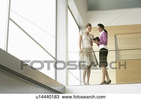 Businesswomen talking on Mezzanine View Large Photo Image Stock Image - Businesswomen talking on Mezzanine. Fotosearch