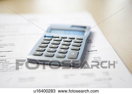 Calculator lying on telephone bill close-up View Large Photo Image Stock Image - Calculator lying on telephone bill close-up. Fotosearch