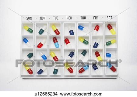 Capsule pills in container with days View Large Photo Image Picture - Capsule pills in container with days. Fotosearch