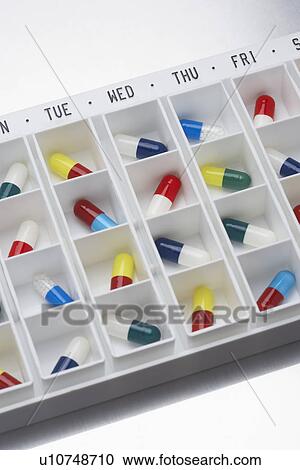 Capsule pills in container with days View Large Photo Image Stock Image - Capsule pills in container with days. Fotosearch