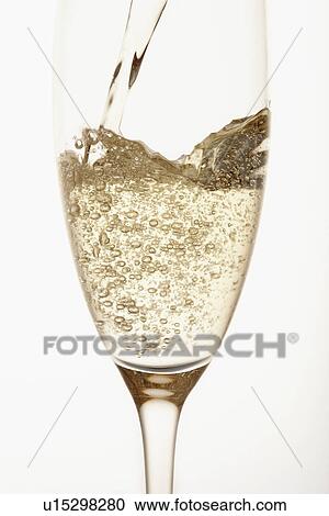Champagne being poured into glass close up in studio View Large Photo Image Stock Image - Champagne being poured into glass close up in studio. Fotosearch