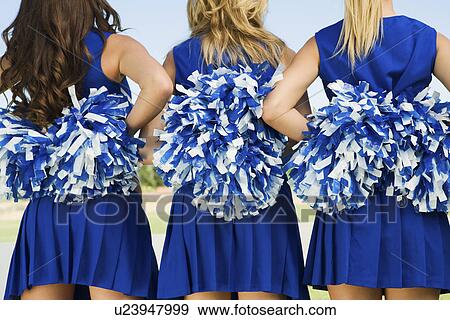 Cheerleaders holding pom-poms rear view (mid section) (close-up) View Large Photo Image Stock Photo - Cheerleaders holding pom-poms rear view (mid section) (close-up). Fotosearch