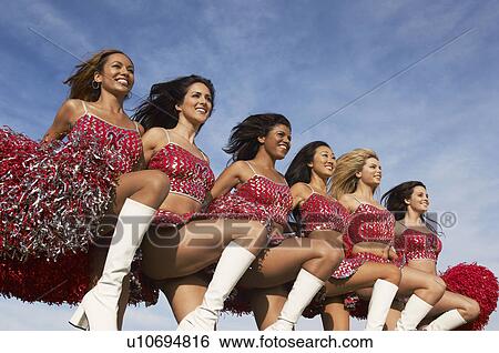 Cheerleaders in a row kicking legs View Large Photo Image Stock Photograph - Cheerleaders in a row kicking legs. Fotosearch