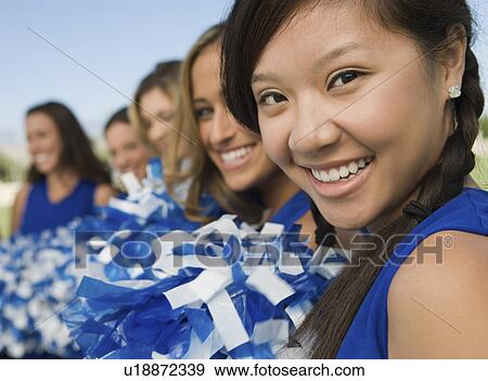 Stock Photo - Cheerleaders sitting on bench (portrait). Fotosearch