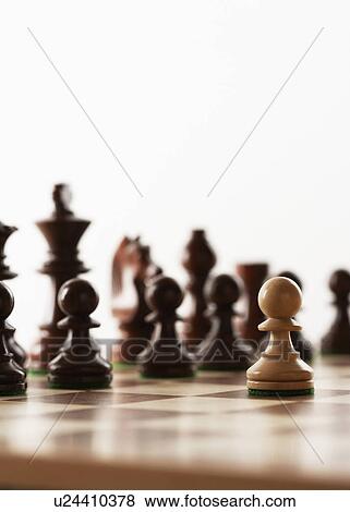 Stock Photo - Chess game one white piece in front of black pieces. Fotosearch