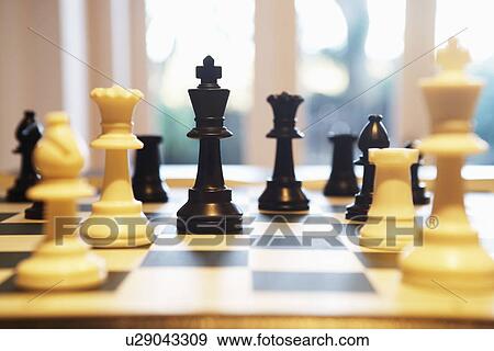 Stock Photo - Chess pieces standing on chess board. Fotosearch