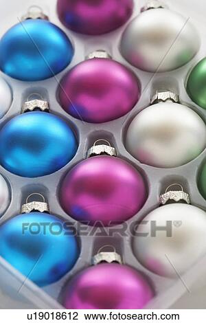 Stock Image - Christmas baubles in tray close-up. Fotosearch