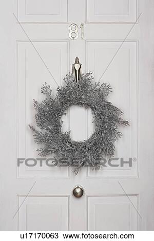 Christmas wreath hanging on white door View Large Photo Image Stock Image - Christmas wreath hanging on white door. Fotosearch