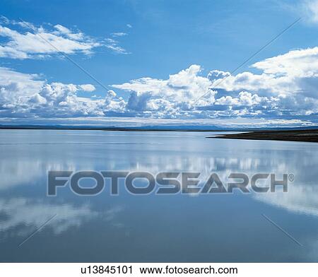 Stock Image - Clouds reflecting on water. Fotosearch