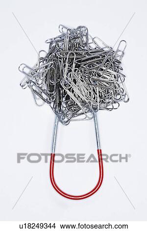 Clump of paperclips attached to horseshoe magnet View Large Photo Image Picture - Clump of paperclips attached to horseshoe magnet. Fotosearch