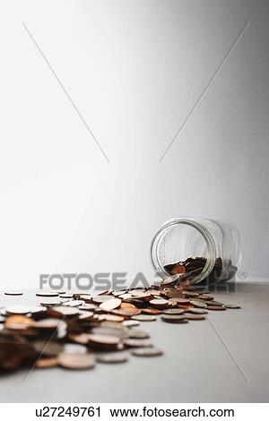 Coins spilling out of jar on its side in studio View Large Photo Image Stock Image - Coins spilling out of jar on its side in studio. Fotosearch