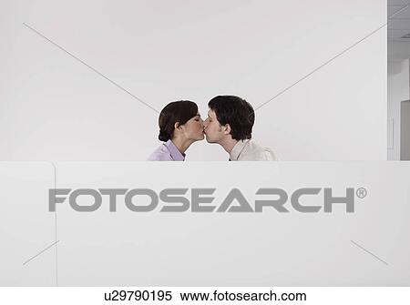 Colleagues kissing in office cubicle View Large Photo Image Stock Photography - Colleagues kissing in office cubicle. Fotosearch
