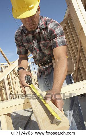 Construction Worker Measuring Timber View Large Photo Image Stock Photography - Construction Worker Measuring Timber. Fotosearch
