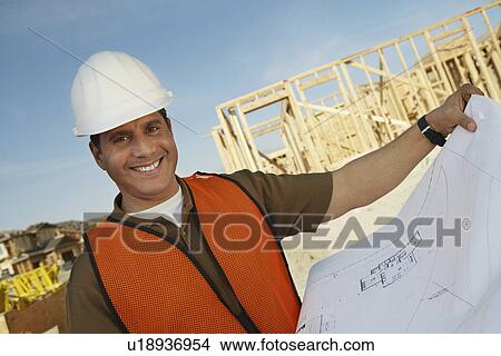 Picture - Construction Worker Reading Blueprints. Fotosearch