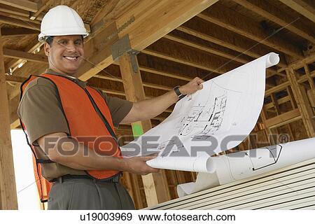 Construction Worker Reading Blueprints View Large Photo Image Stock Photo - Construction Worker Reading Blueprints. Fotosearch