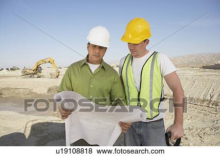 Stock Photo - Construction Workers Reading Blueprints. Fotosearch