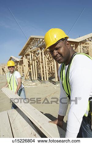 Picture - Construction Workers Stacking Timber. Fotosearch