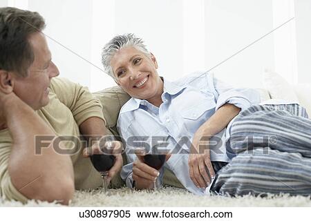 Couple drinking wine on rug in home View Large Photo Image Stock Photography - Couple drinking wine on rug in home. Fotosearch