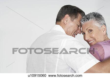 Couple embracing against white background portrait View Large Photo Image Stock Image - Couple embracing against white background portrait. Fotosearch