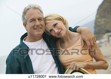 Couple embracing at beach (portrait) View Large Photo Image Stock Image - Couple embracing at beach (portrait). Fotosearch