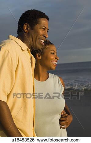 Couple embracing at ocean View Large Photo Image Stock Photograph - Couple embracing at ocean. Fotosearch