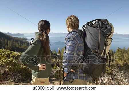 Stock Image - Couple hiking at coast. Fotosearch