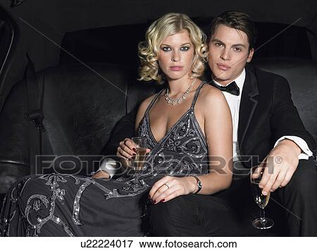 Couple in back of car drinking champagne eye contact View Large Photo Image Stock Photo - Couple in back of car drinking champagne eye contact. Fotosearch