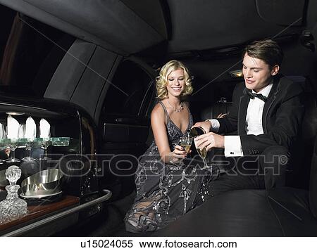 Couple in back of limousine drinking champagne View Large Photo Image Stock Photography - Couple in back of limousine drinking champagne. Fotosearch