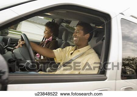Couple in car man driving side view View Large Photo Image Stock Image - Couple in car man driving side view. Fotosearch