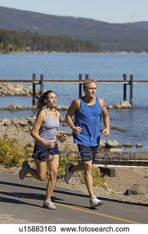 Couple jogging beside lake View Large Photo Image Stock Image - Couple jogging beside lake. Fotosearch