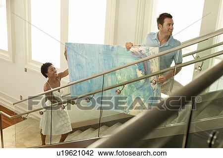 Couple moving modern painting up stairs elevated view View Large Photo Image Stock Image - Couple moving modern painting up stairs elevated view. Fotosearch