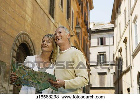 Stock Photo - Couple on street with map in Rome Italy low angle view. Fotosearch