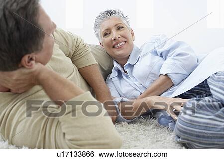 Couple relaxing in home View Large Photo Image Stock Photograph - Couple relaxing in home. Fotosearch
