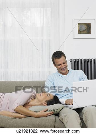 Couple Relaxing on Sofa View Large Photo Image Stock Image - Couple Relaxing on Sofa. Fotosearch
