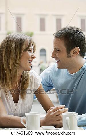 Stock Photo - Couple sitting at outdoor cafe in Rome close up. Fotosearch
