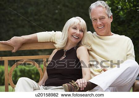 Couple Sitting on Bench in Garden View Large Photo Image Stock Image - Couple Sitting on Bench in Garden. Fotosearch