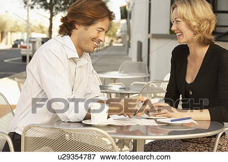 Couple smiling at outdoor cafe View Large Photo Image Stock Photo - Couple smiling at outdoor cafe. Fotosearch