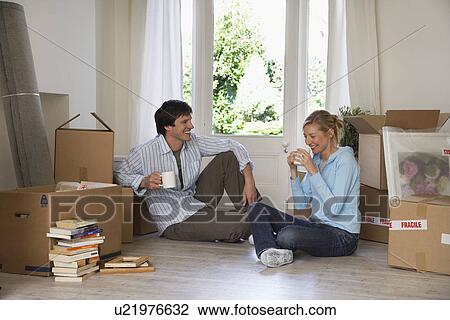 Couple taking a break among moving boxes View Large Photo Image Stock Image - Couple taking a break among moving boxes. Fotosearch