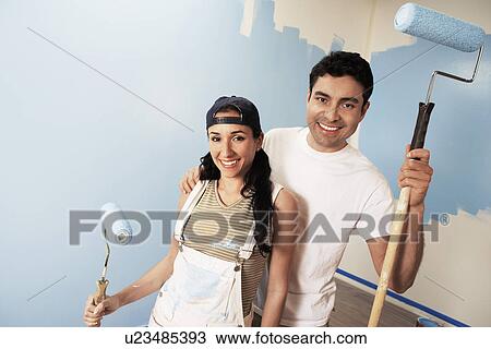Couple with paint rollers portrait View Large Photo Image Stock Image - Couple with paint rollers portrait. Fotosearch