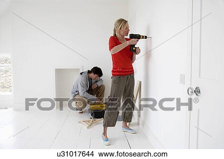 Couple working on their new home View Large Photo Image Picture - Couple working on their new home. Fotosearch