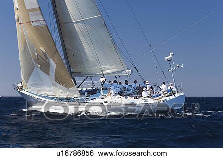 Crew sitting on sailboat on ocean View Large Photo Image Stock Photograph - Crew sitting on sailboat on ocean. Fotosearch