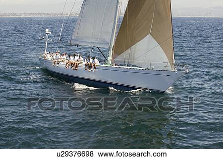 Crew sitting on side of sailboat elevated view View Large Photo Image Stock Photo - Crew sitting on side of sailboat elevated view. Fotosearch