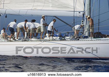 Crew working on sailboat View Large Photo Image Stock Image - Crew working on sailboat. Fotosearch