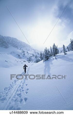 Stock Photo - Cross country skier in mountains. Fotosearch