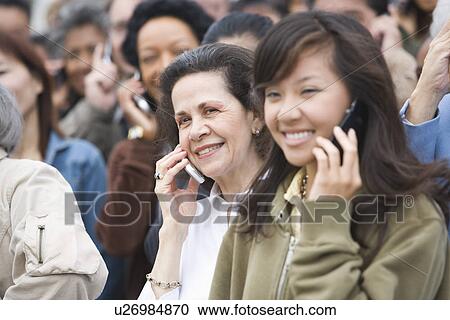 Stock Image - Crowd using mobile phones. Fotosearch