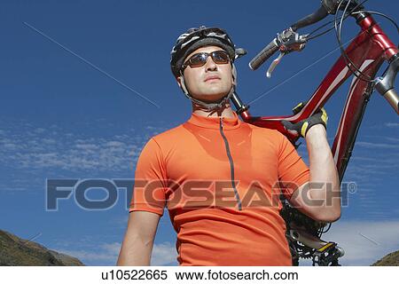 Cyclist carrying bike View Large Photo Image Stock Photography - Cyclist carrying bike. Fotosearch